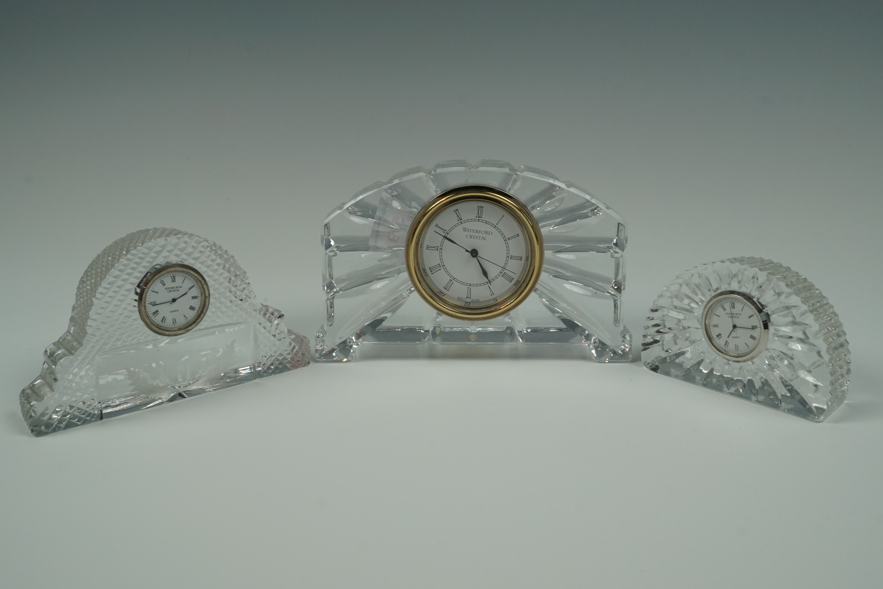 A Waterford and two Edinburgh Crystal clocks, former 17 cm x 11 cm