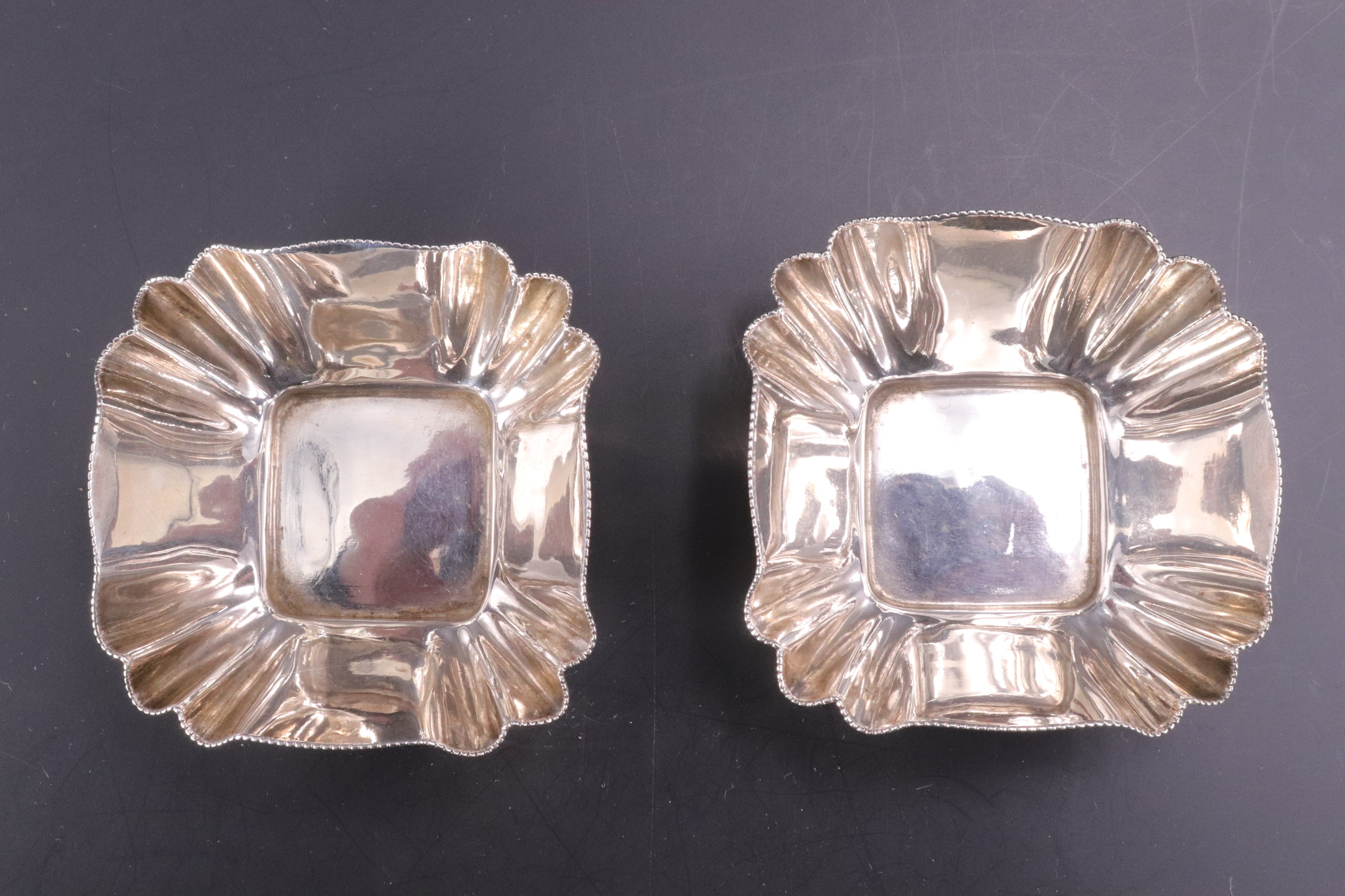 A pair of late Victorian silver salt cellars, each of cusped square section with a millegrain rim, - Image 2 of 3