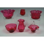 Sundry items of antique cranberry glass including a basket, bowls and jugs