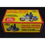 A Telsalda clockwork toy Police Patrol Motorcyclist in original carton