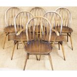 A set of six Ercol Windsor style dining chairs comprising five standard and one arm chair,