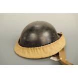A Second World War Home Front Plasfort type helmet and rubber-proofed canvas helmet carrier