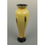 A Caithness "Ebony" glass vase, of slender inverted baluster form with flared neck and foot, in a