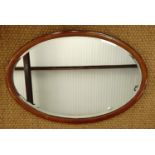 A Victorian oval inlaid mahogany mirror, 94 × 64 cm