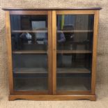 A pair of George V glazed mahogany bookcases, 112 cm x 30 cm x 112 cm and 95 cm x 30 cm x 112 cm