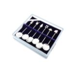 A cased set of six Japanese white-metal coffee spoons, the terminals modelled as various objects and
