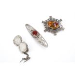 Three vintage white metal brooches, comprising an early 20th Century Arts and Crafts style