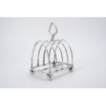 An Edwardian silver toast rack, of arcaded form, Harrison Brothers and Howson, Sheffield, 1907,