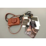 A Leica D-Lux 4 digital compact camera, with 1:2.0-2.8/5.1-12-8 ASPH lens, in brown leather carry