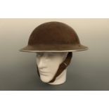 A Second World War British army or Home Guard steel helmet bearing a circular formation sign and