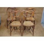 A set of four Victorian cane-seated balloon back bedroom chairs