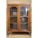 A late 19th / early 20th Century glazed mahogany bookcase on short cabriole legs, 103 cm x 145 cm