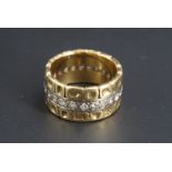 A modernist diamond and 18ct band, comprising a central band of millegrain-set diamond brilliants of