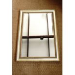 A large gilt-framed rectangular mirror, 106 cm x 75 cm