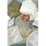 Vintage hand-embroidered domestic linens, including a linen wall hanging depicting a vase of