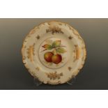 A Minton hand enamelled and gilt plate depicting an apple bough, decorated by W. R Tipton, 23 cm