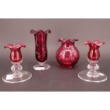 A collection of Royal Scot Cranberry Glass, including trumpet vase, a pair of candlesticks, and