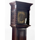 A George V Jacobean revival influenced oak cased long case clock, having a brass-faced 8-day