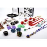 A quantity of vintage costume jewellery, including statement ear clips, a millefiori necklace,