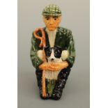 A Shebag Isle of Man Pottery figurine modelled as a shepherd and his sheep dog, D Thomson, 11 cm