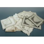 A quantity of vintage neutral toned hand-embroidered table linens, including an Edwardian tea