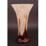 A WMF Ikora glass vase, of trumpet form, having an opaque patterned ground leading into an amber