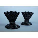 A pair of Victorian pressed black glass fan shaped bud vases, 8 cm