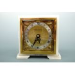 An Elliott white onyx mantle clock retailed by the Northern Goldsmiths of Newcastle-Upon-Tyne,