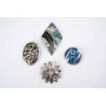 A collection of four Mexican white metal pendant brooches, inlaid in various geometrical designs,