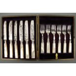 A Victorian cased set of six mother of pearl handled fruit knives and forks, with silver ferrules,