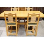 A Beaver Furniture oak dining suite, comprising an adzed oak table with two extension leaves and