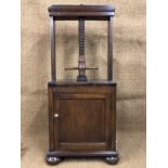 An early 19th Century oak linen screw press cabinet