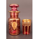 A mid 19th Century Bohemian style ruby flashed, facet cut and gilded beaker, together with similar