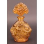 An antique French pressed glass perfume bottle with ground-in lapidary stopper, of opaque honey
