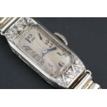 A 1920s lady's Art Deco precious white metal (stamped platinum) and diamond wristlet watch, the