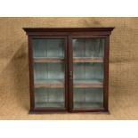 A Victorian glazed pine bookcase, its adjustable wooden shelves having gilt-tooled leather aprons,