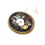 A Victorian pietra dura and yellow-metal brooch, of oval section, depicting a bouquet of garden