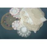 A quantity of antique and vintage doilies and antimacassars, worked in white and pastel colours