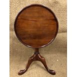 A quality reproduction mahogany snap-top wine table, having a tray top, triple-cluster column and