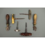 A small collection of antique bottle openers and can openers