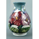 A contemporary Moorcroft baluster vase, the decoration depicting pansies, signed and printed