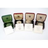 Four cased Royal Mint silver proof coins comprising a crown, two St Helena tercentenary 25p and a