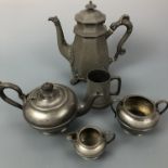 An antique pewter tea set, comprising tea pot, sugar bowl and milk, together with a pewter coffee