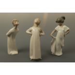 Two Lladro figurines, young boy and girl together with a Nao figurine of a young girl, tallest 20