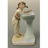 A Lladro figurine, young girl at sink, 18 cm high