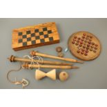 Vintage wooden games including solitaire, chess, a spinning top and skittles