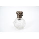 A Victorian silver mounted cut glass scent bottle, of grenade form, having a silver pommel with