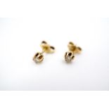 A pair of diamond stud earrings, each of approximately .10ct, claw set in yellow metal, tested as