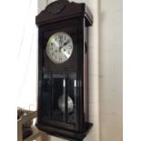 A 1920s - 1930s mahogany cased wall clock, with silvered dial and Arabic numerals, 78 cm