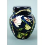 A contemporary Moorcroft covered jar, the decoration depicting budding flowers, signed and printed